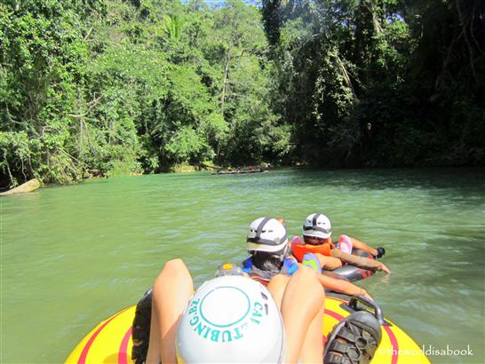 Belize cave tubing floating in river