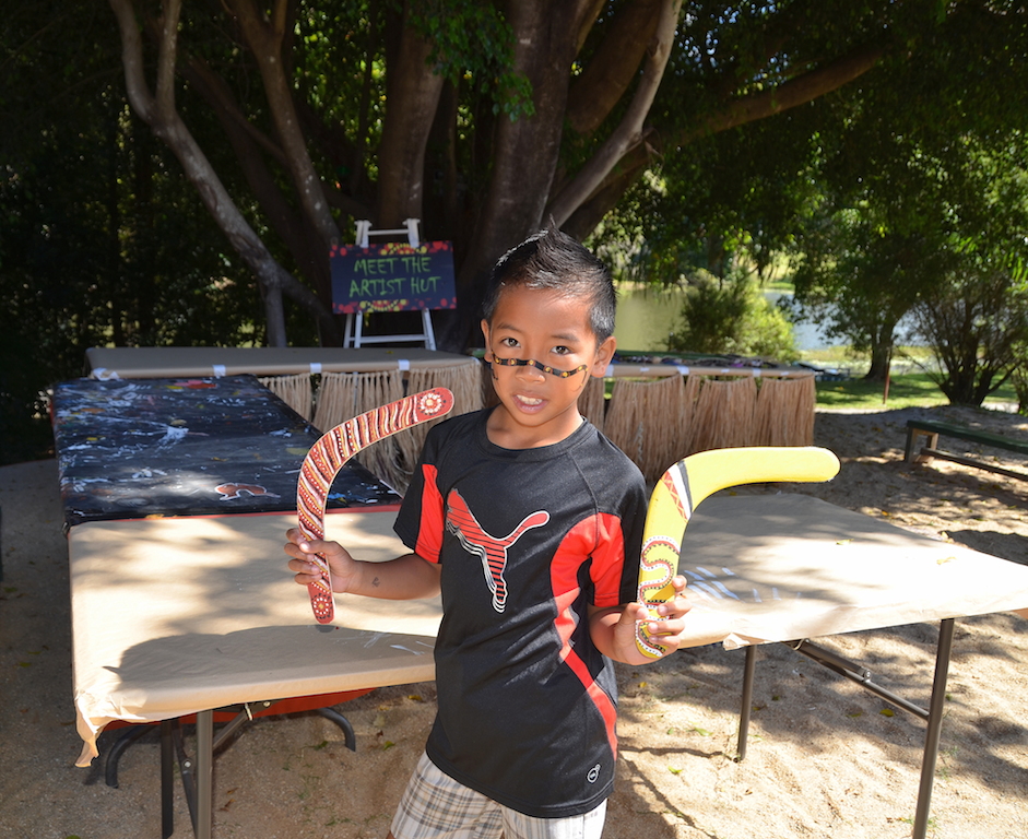 Tjapukai Aboriginal park kid with boomerangs